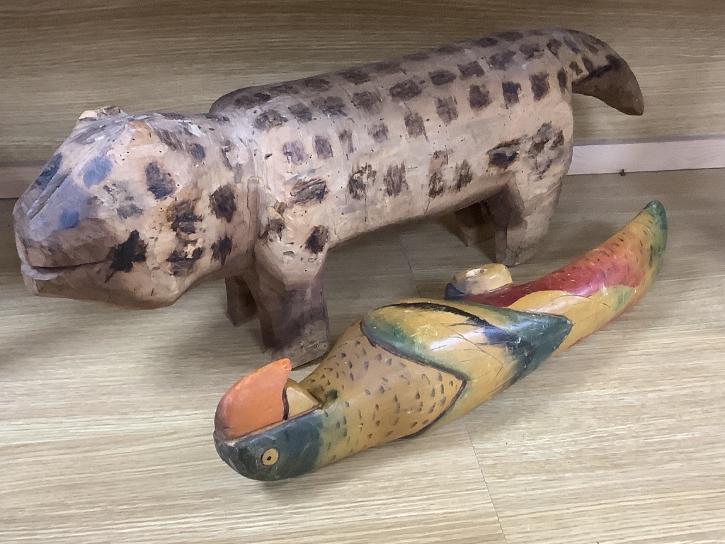 A decorative 20th century Brazilian carved wood dog and a painted carved wood parrot (2)